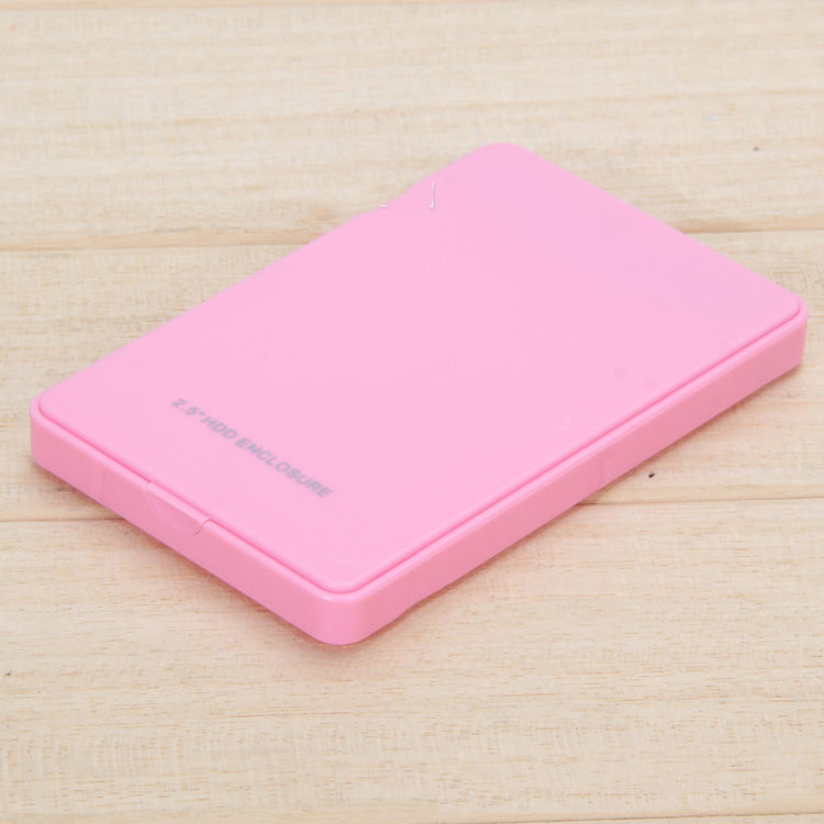 a pink hard drive on a wood surface