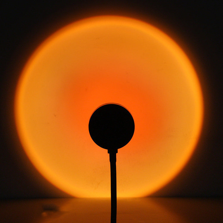 a silhouette of a microphone in front of a bright circle