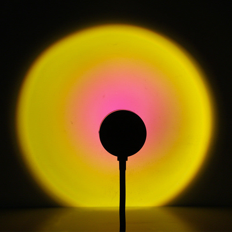 a round object with a yellow and pink circle in the background