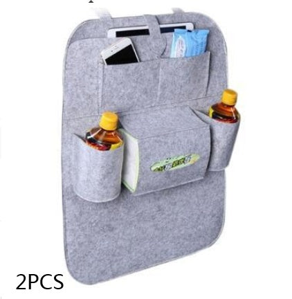 a grey car seat with a pocket and a phone and other items