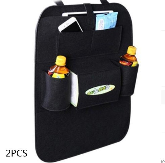 a black car seat back pocket with a phone and drinks inside