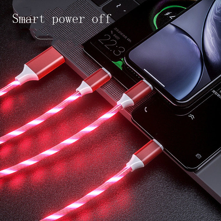 a cell phone charging on a laptop
