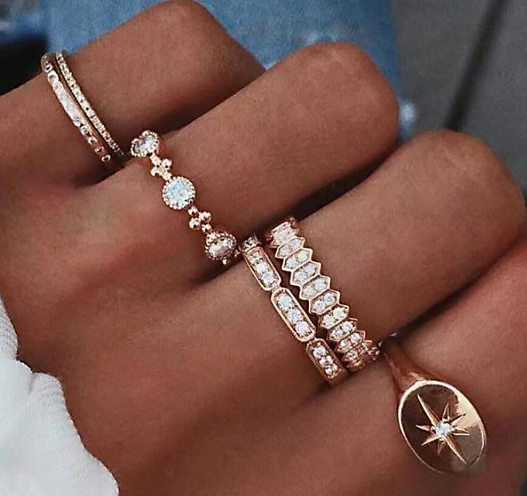 a hand with many different jewelry