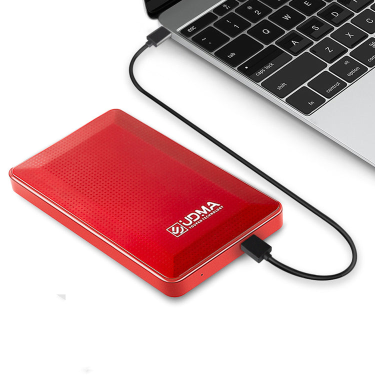 a red hard drive connected to a laptop