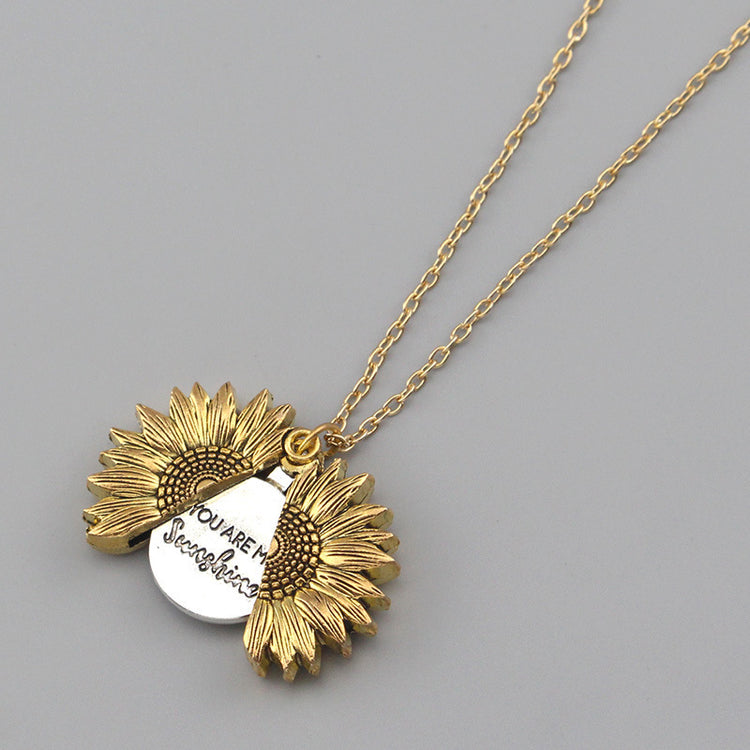a necklace with a sunflower pendant