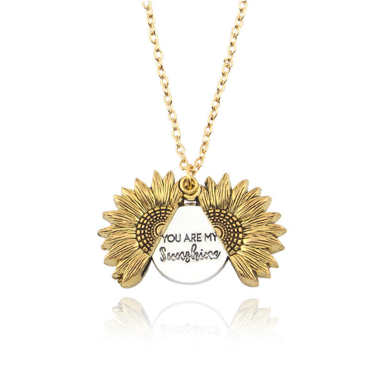 a necklace with a pendant and sunflowers