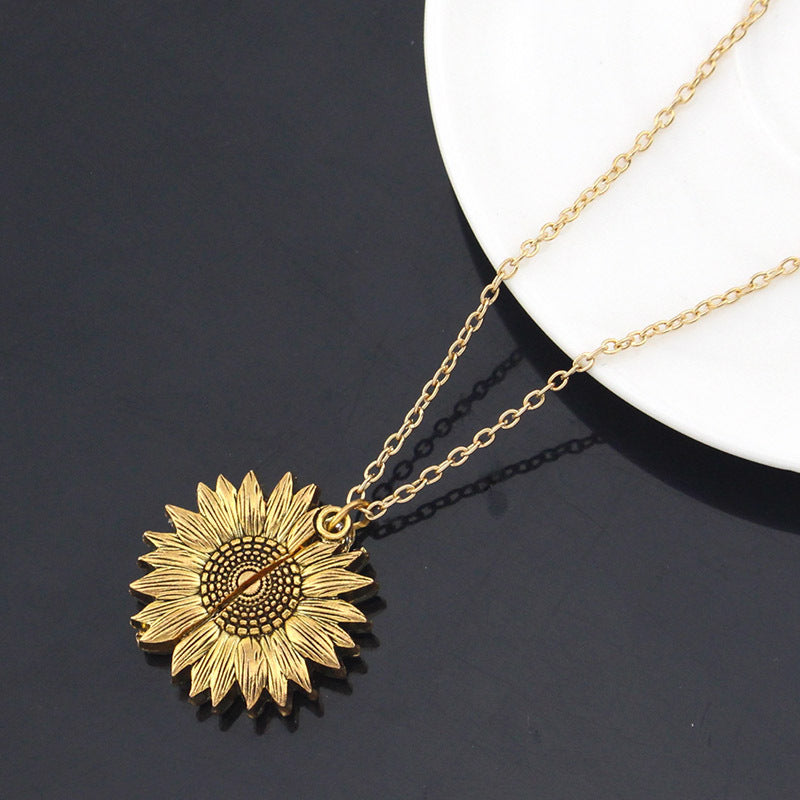 a necklace with a sunflower pendant