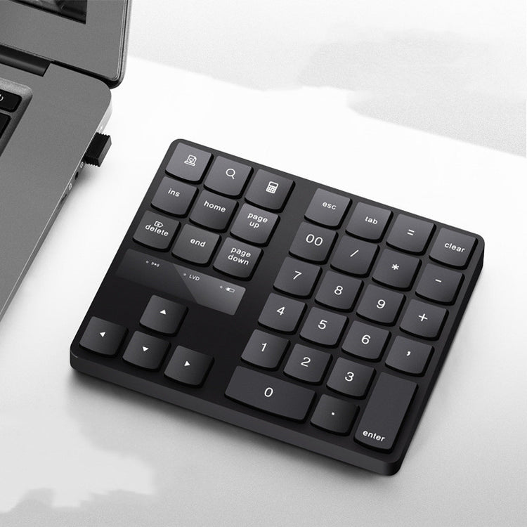 a black keyboard next to a laptop