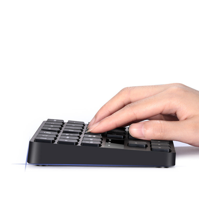 a hand pressing a keyboard