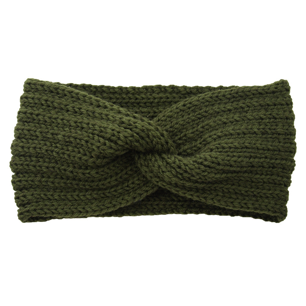 a green knit headband with a knot