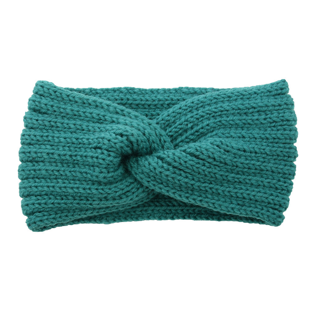 a green knit headband with a knot