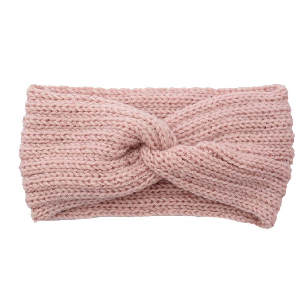 a pink knit headband with a knot