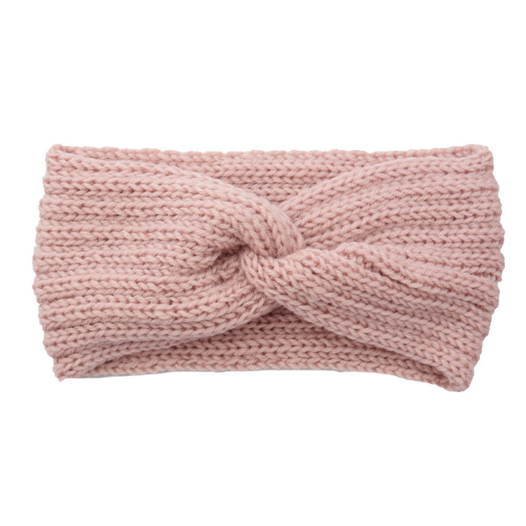 a pink knit headband with a knot