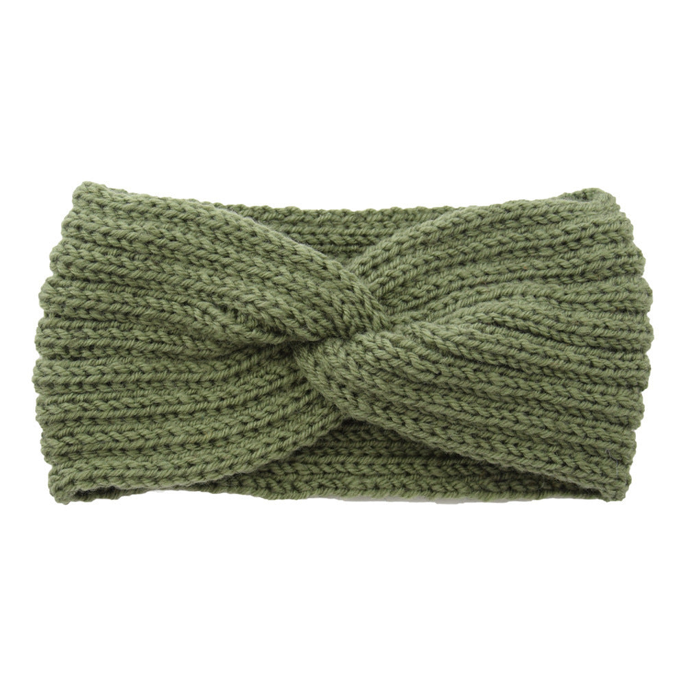 a green knit headband with a knot