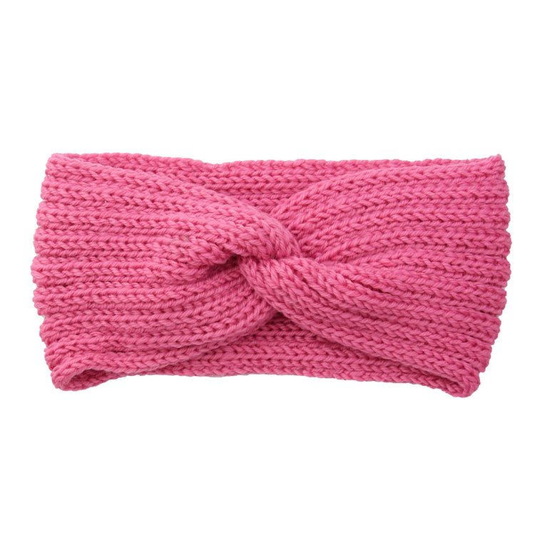 a pink knit headband with a knot