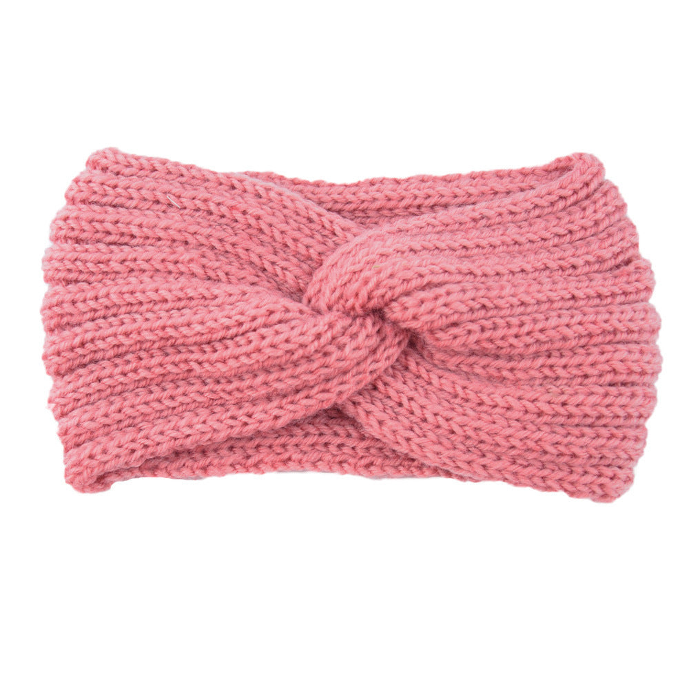 a pink knit headband with a knot