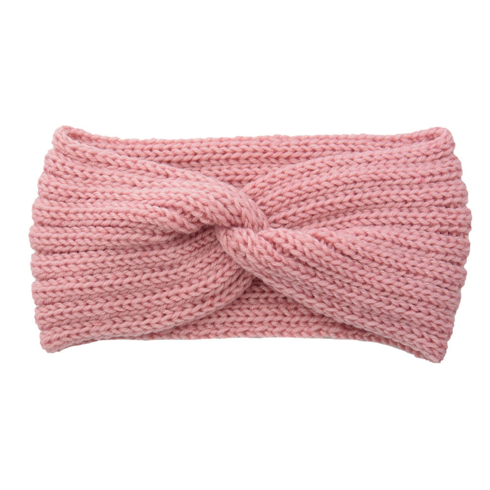a pink knit headband with a knot
