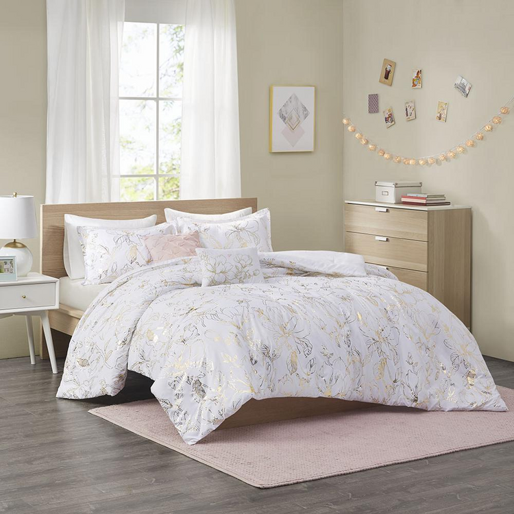 a bed with a white comforter and pillows