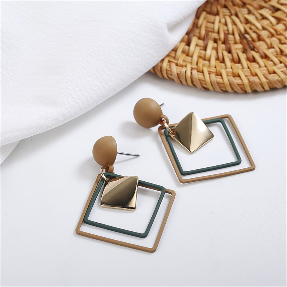 a pair of earrings on a white surface