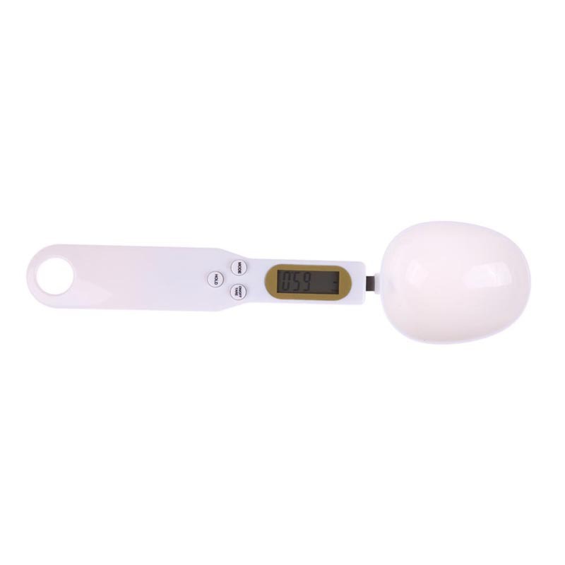 a white measuring spoon with a digital display