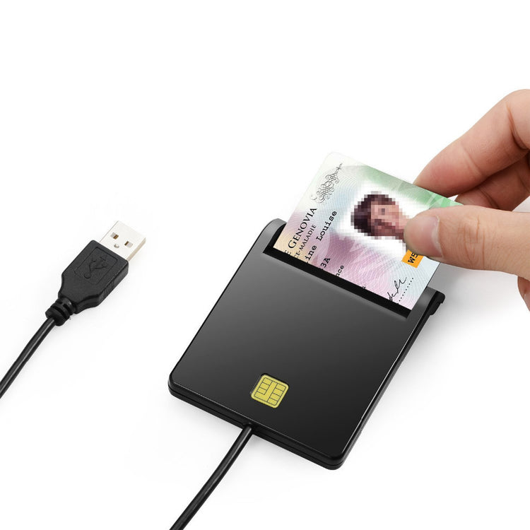 a hand holding a card to a usb cable