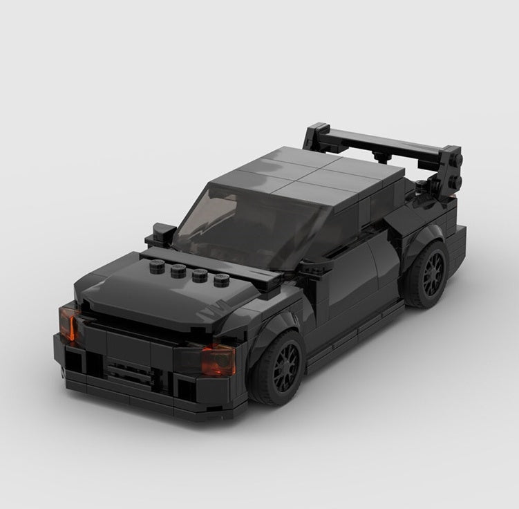 a black car with a large wing