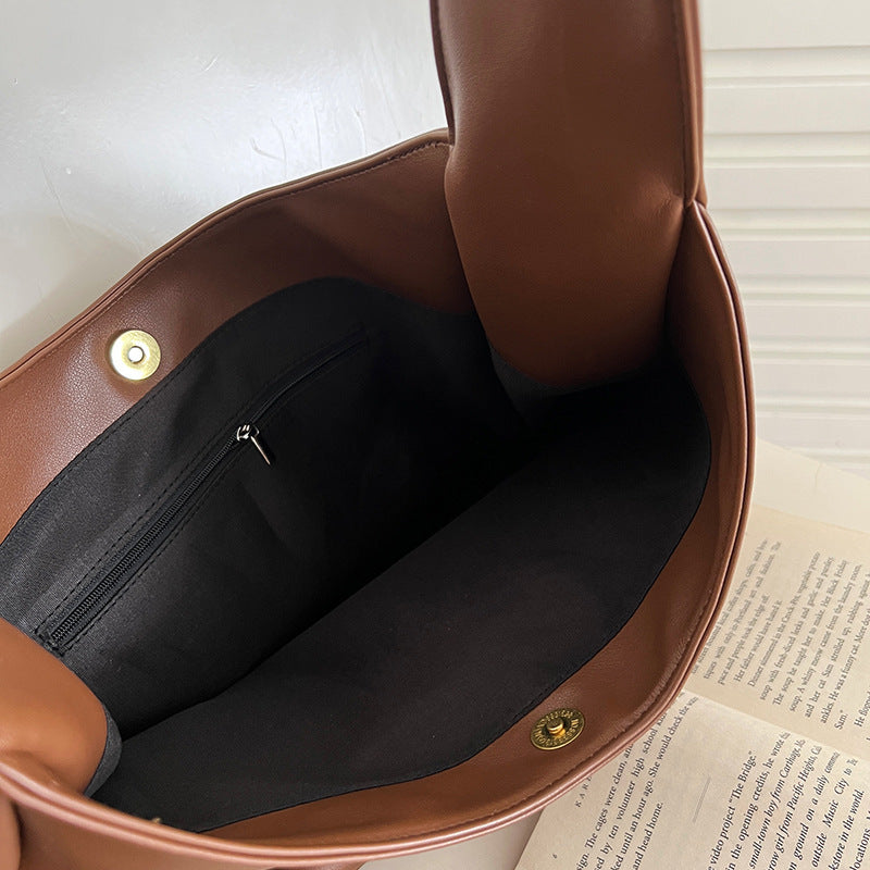 a brown purse with a black pocket