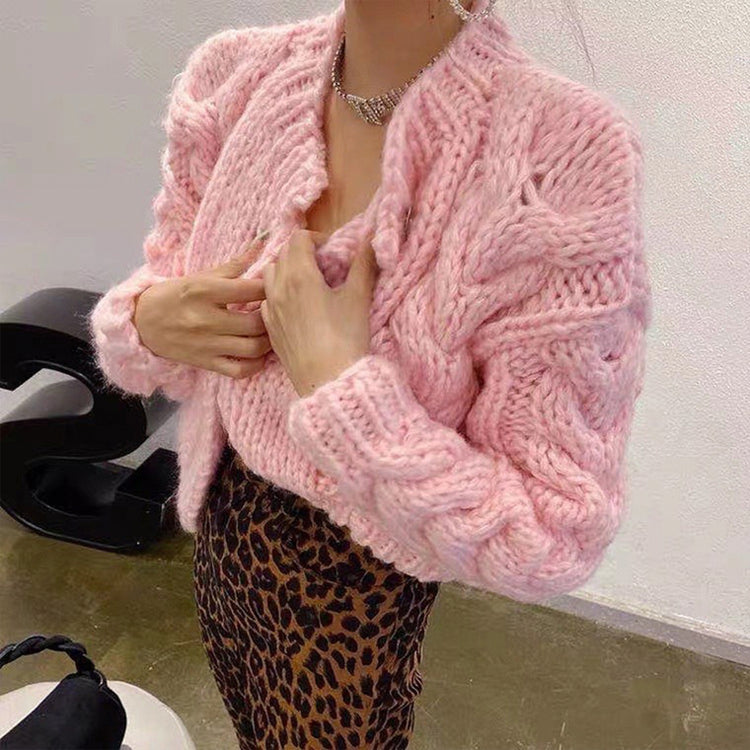 a woman wearing a pink sweater and leopard print skirt