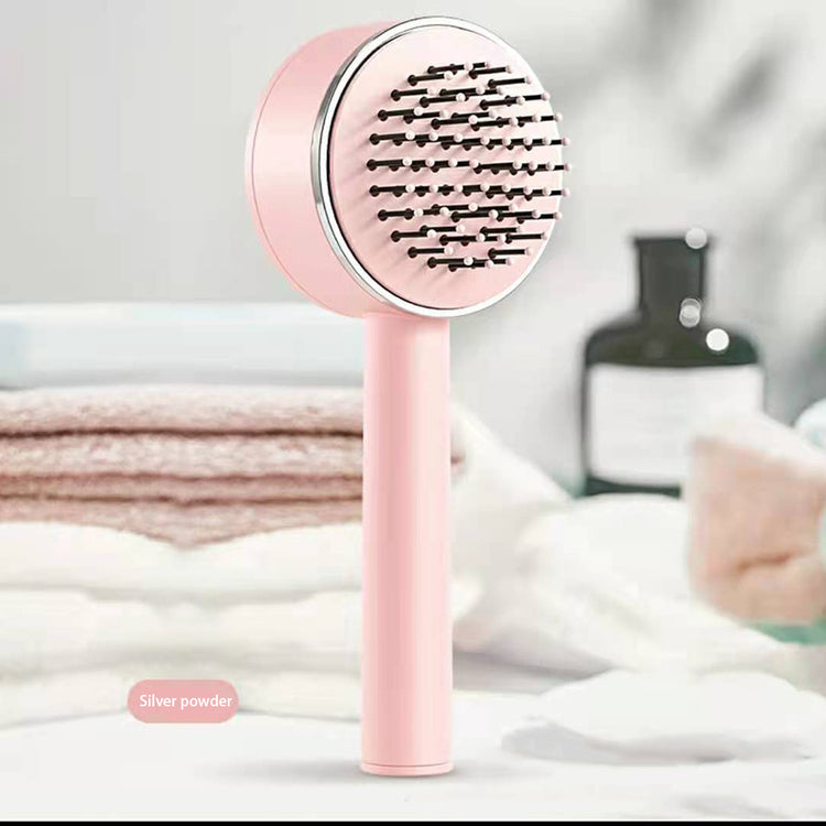 a pink hair brush on a table
