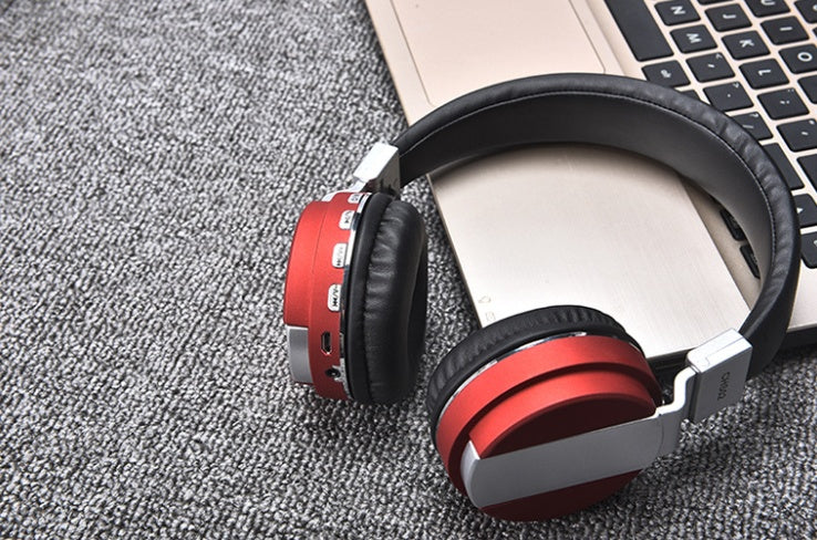 a pair of headphones next to a laptop