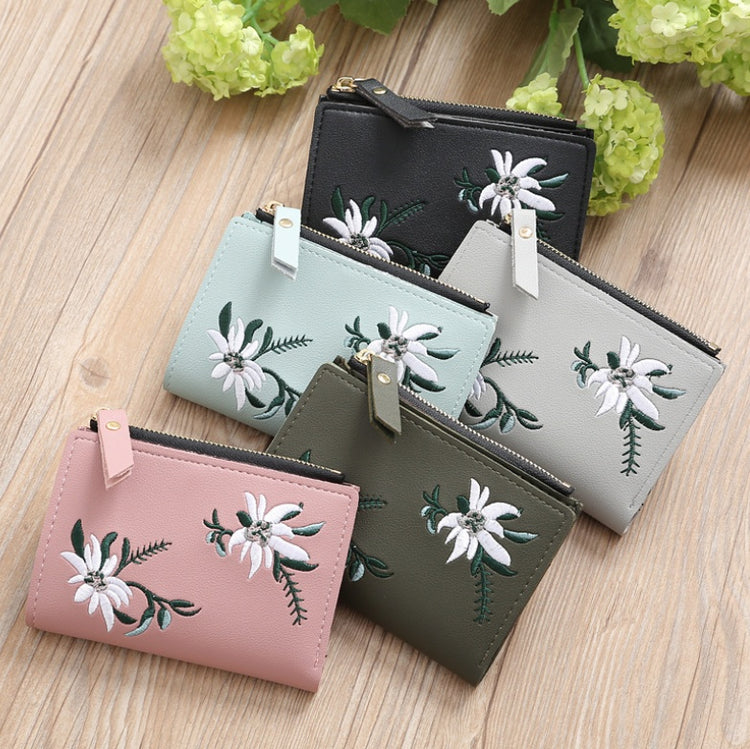a group of wallets with flowers on a table