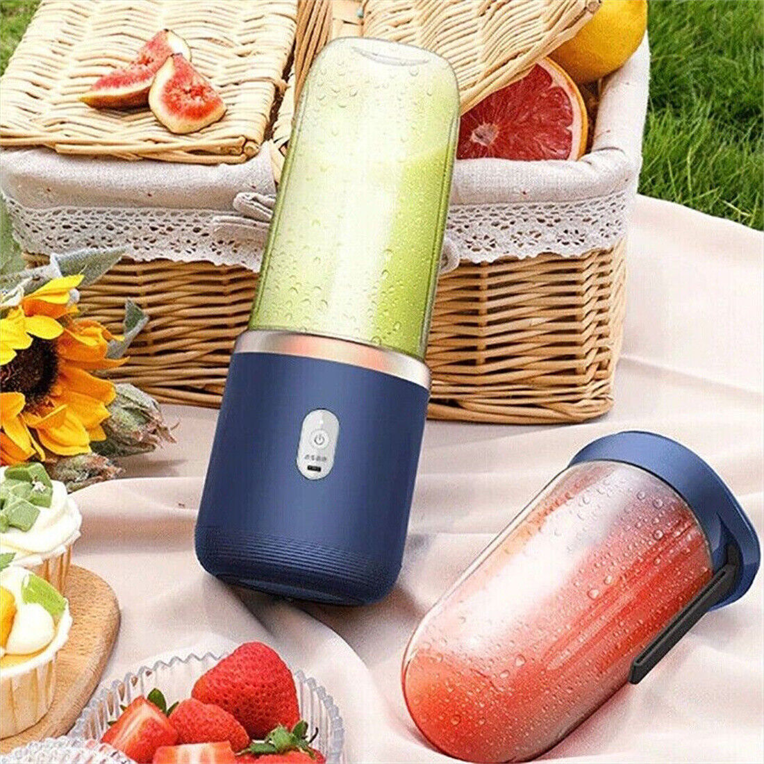 a blender on a blanket with fruit and a basket