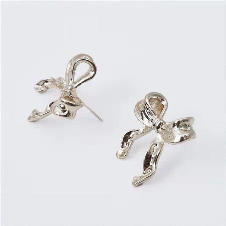 a pair of earrings with bows