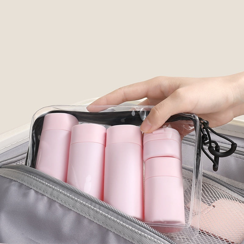 a hand holding a bag of cosmetics