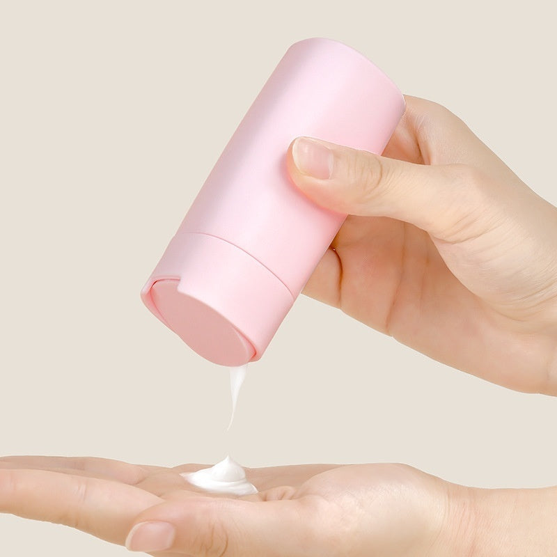 a person pouring cream onto their hand