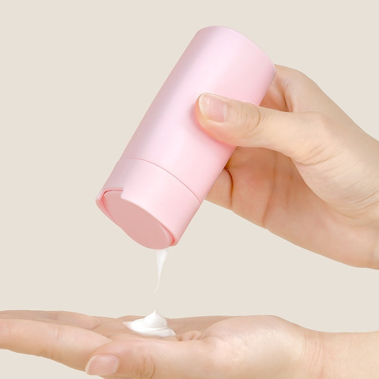 a person pouring cream onto their hand