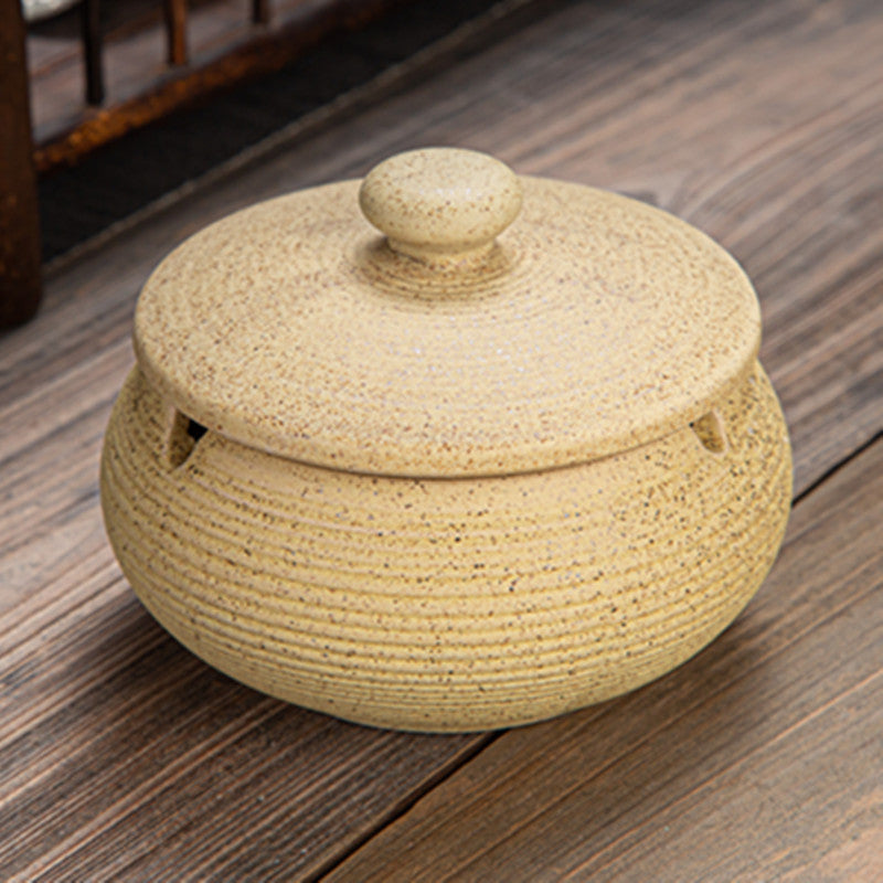 a small ceramic container on a wood surface