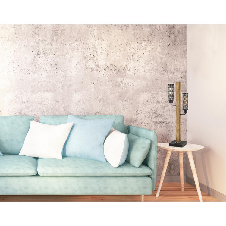 a blue couch with white pillows next to a table