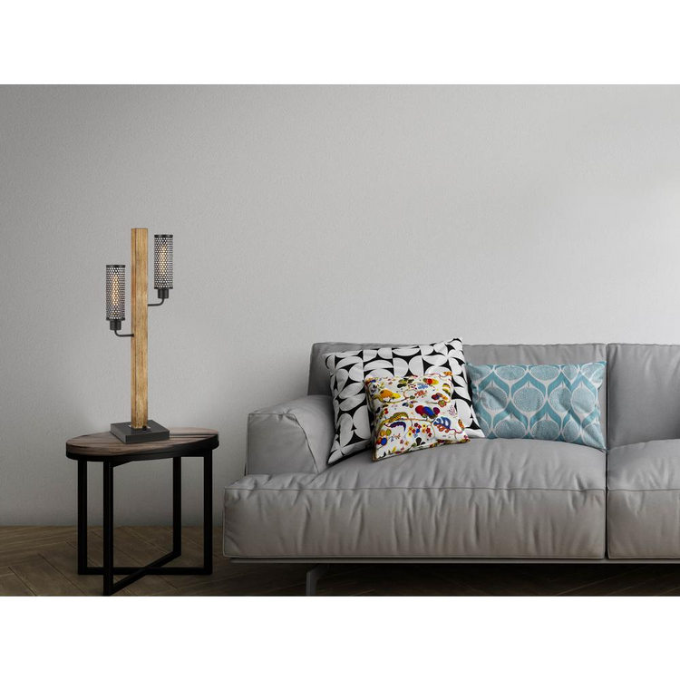 a couch with pillows and a lamp on a table