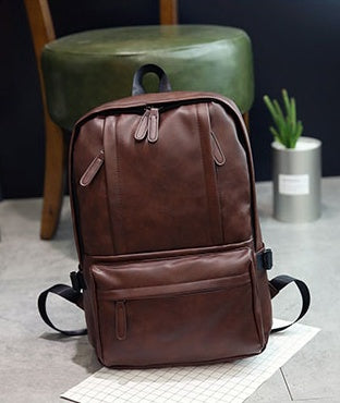 a brown backpack on a piece of paper