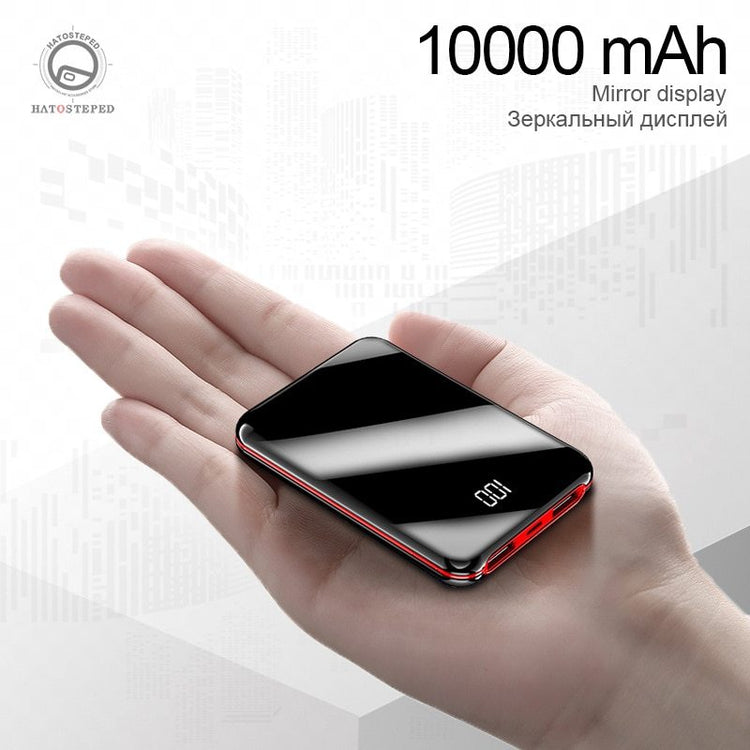 a hand holding a black rectangular device