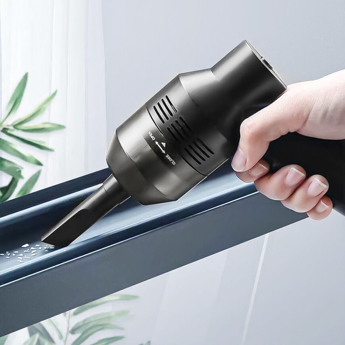 a hand holding a vacuum cleaner