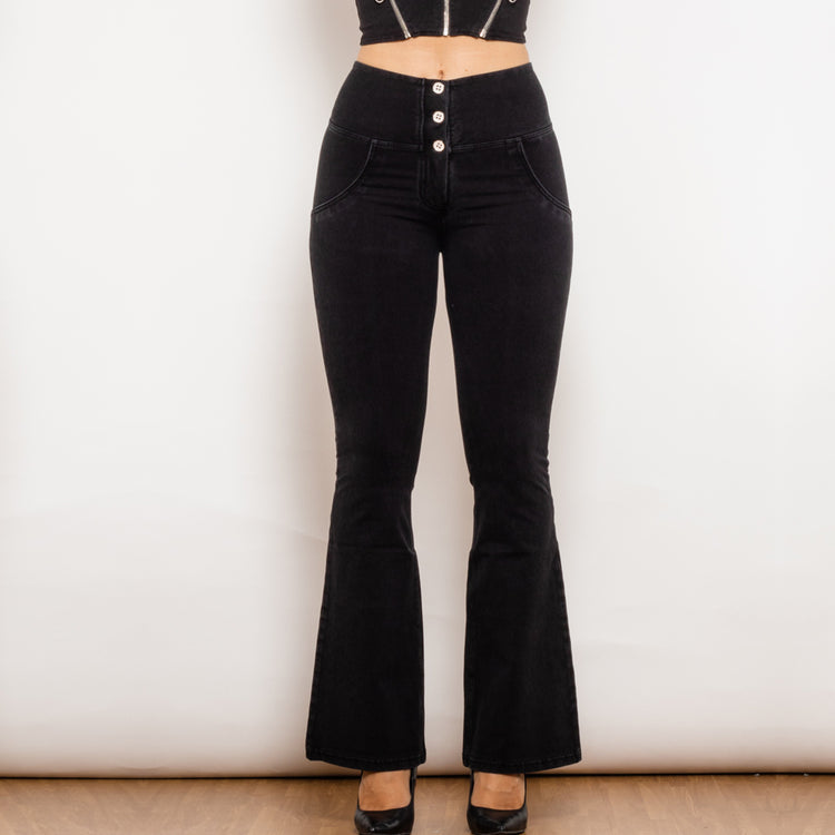 a woman wearing black jeans and a black top