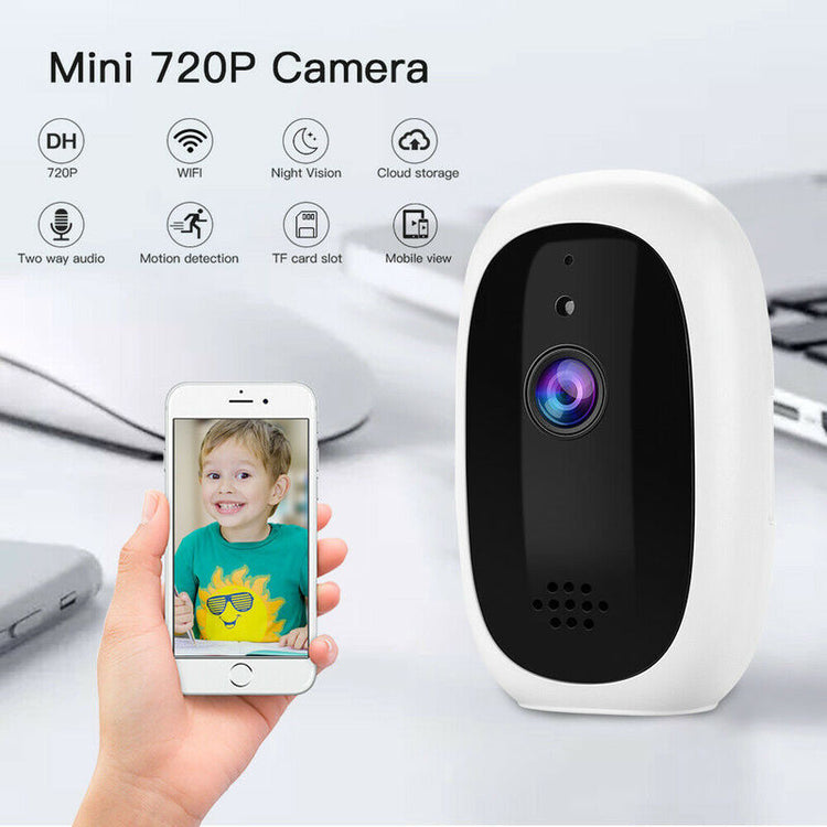 a hand holding a phone next to a camera