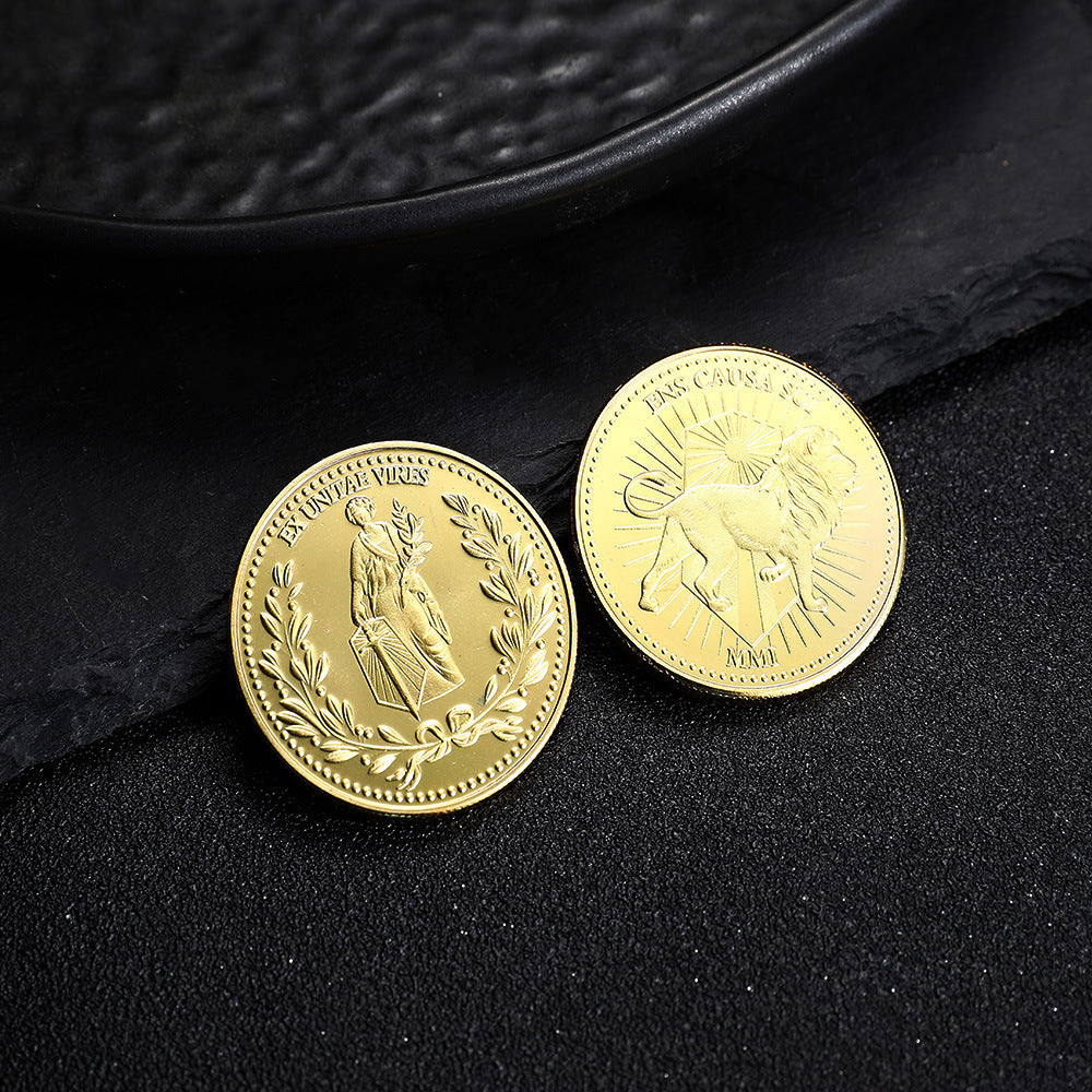 two gold coins on a black surface