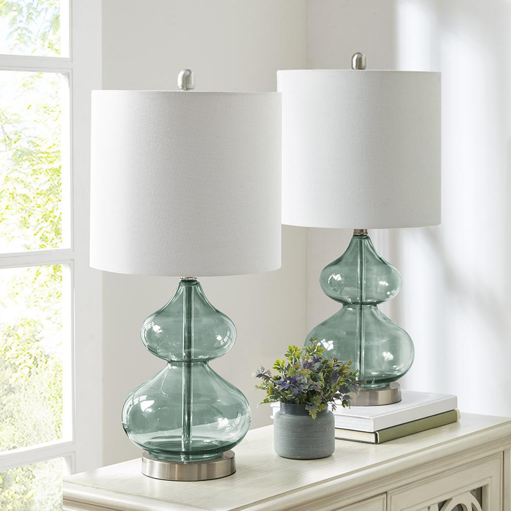 a table with two lamps and a plant on it