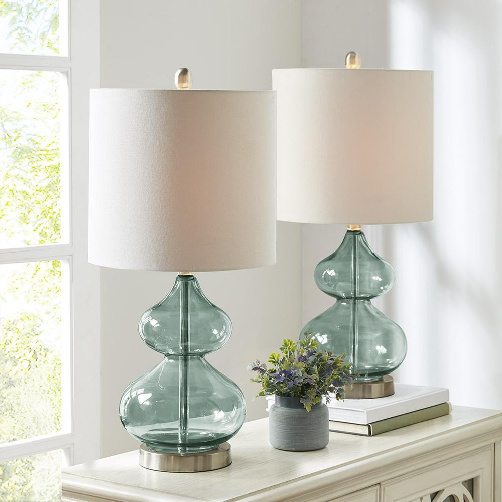 a table lamp with a vase of flowers and a plant on it
