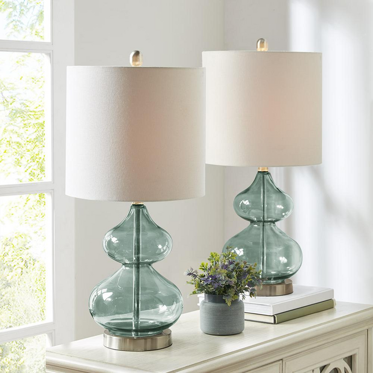 a table lamp with a vase of flowers and a plant on it