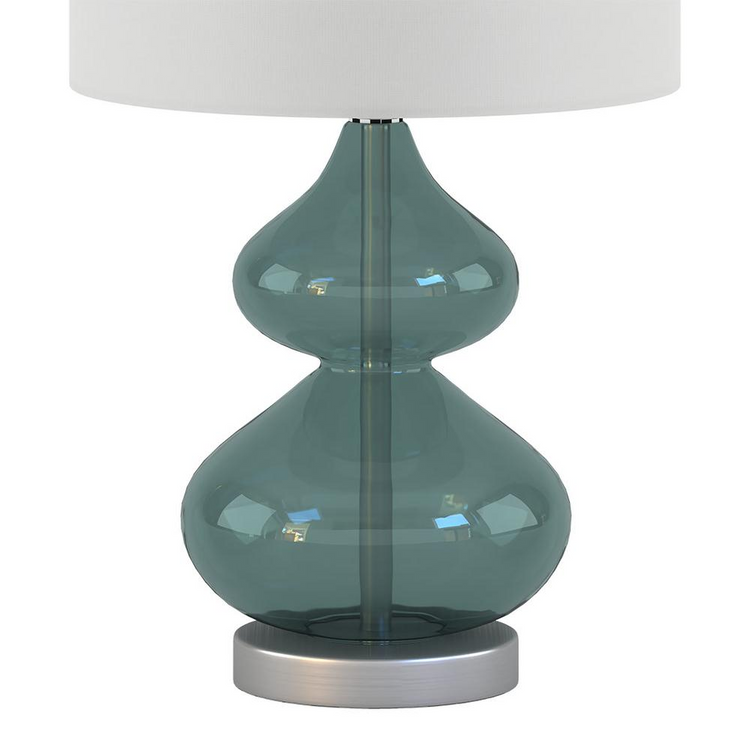 a glass lamp with a white shade