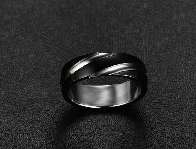a silver ring on a black surface